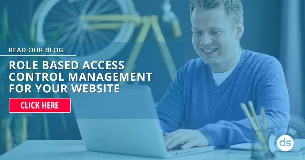Smiling professional working on a laptop with a blog post about Role Based Access Control management onscreen.