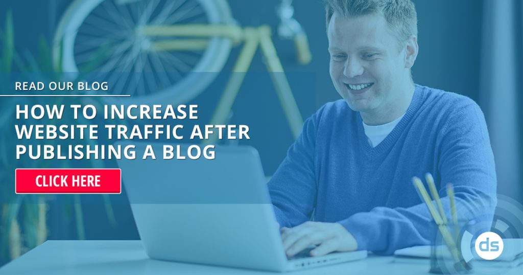 Man smiling while working on a laptop with an advertisement for a blog post on increasing website traffic in the foreground, just after publishing the blog.